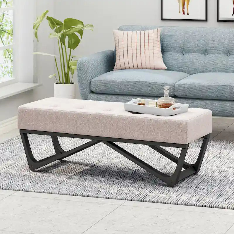 Banc-ottoman en tissu capitonné avec pieds en bois courbé