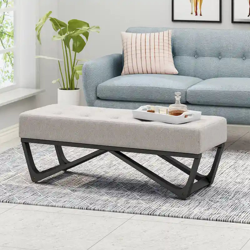 Banc-ottoman en tissu capitonné avec pieds en bois courbé