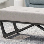 Banc-ottoman en tissu capitonné avec pieds en bois courbé