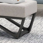 Banc-ottoman en tissu capitonné avec pieds en bois courbé