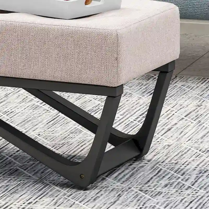 Banc-ottoman en tissu capitonné avec pieds en bois courbé