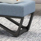 Banc-ottoman en tissu capitonné avec pieds en bois courbé